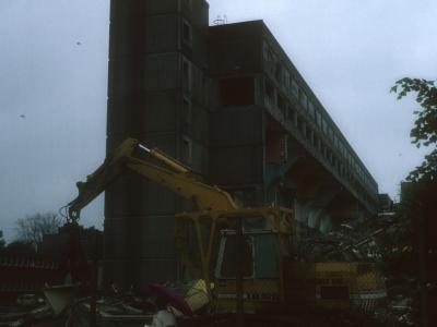 View of 7-storey blocks undergoing demolition with 24-storey block to right of image
